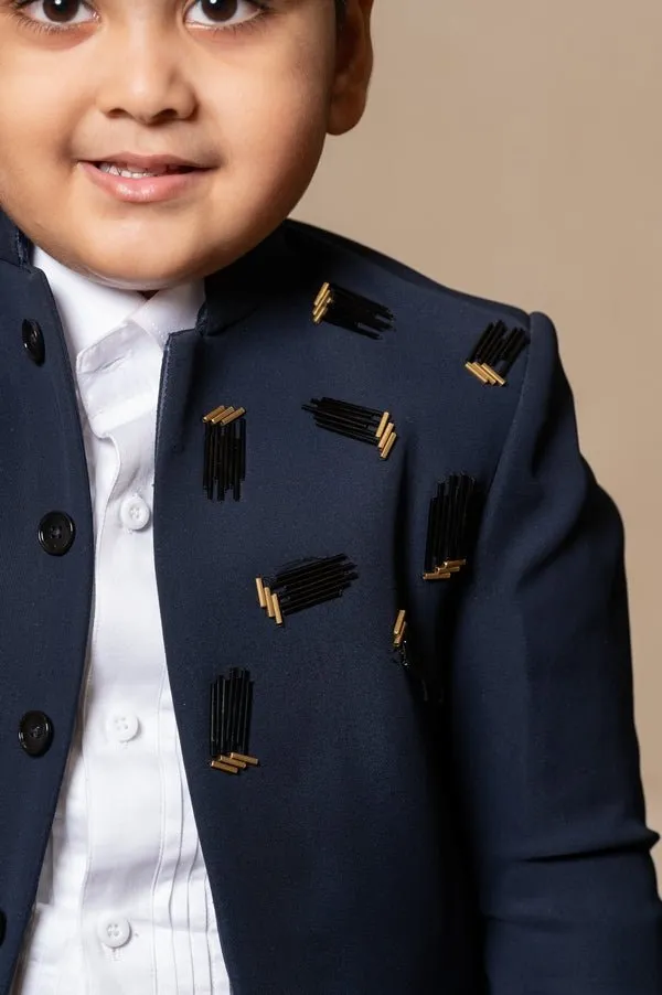 Navy blue blazer with elegant metallic embroidery, paired with matching trousers and a crisp white shirt for a refined formal look