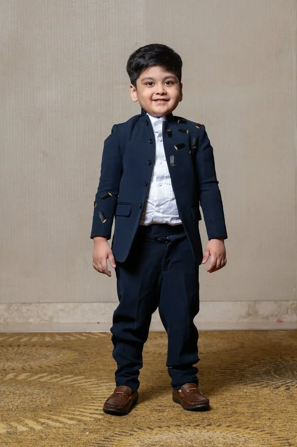 Navy blue blazer with elegant metallic embroidery, paired with matching trousers and a crisp white shirt for a refined formal look