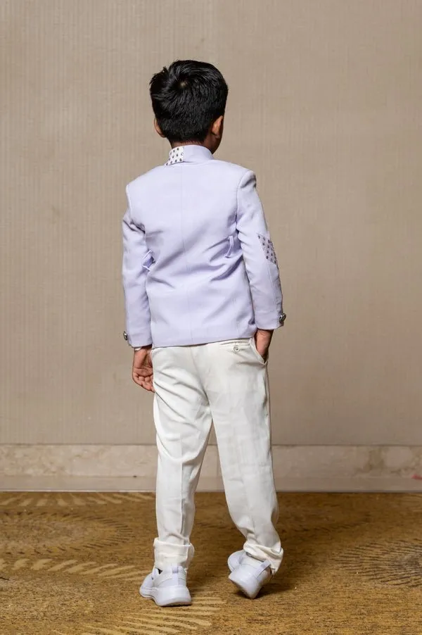 Trendy lavender blazer with metallic stud embellishments paired with classic white trousers, perfect for the modern young gentleman.