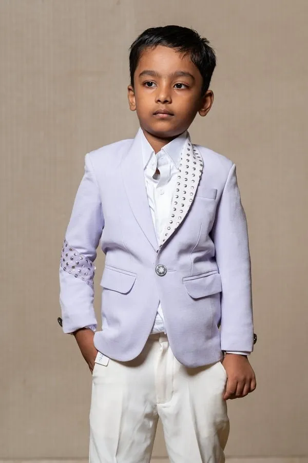 Trendy lavender blazer with metallic stud embellishments paired with classic white trousers, perfect for the modern young gentleman.